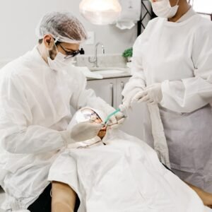 Prótesis Dental en Bizkaia. woman in white scrub suit holding white and green hose